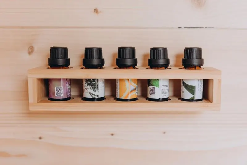 Essential oils on a cedar shelf for sauna aromatherapy