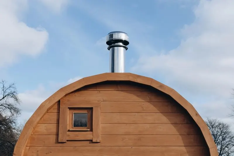 The sauna's stainless chimney against the sky